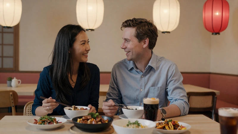 Multicultural couple sharing an Asian meal together in a warm cozy restaurant setting representing cross-cultural dating