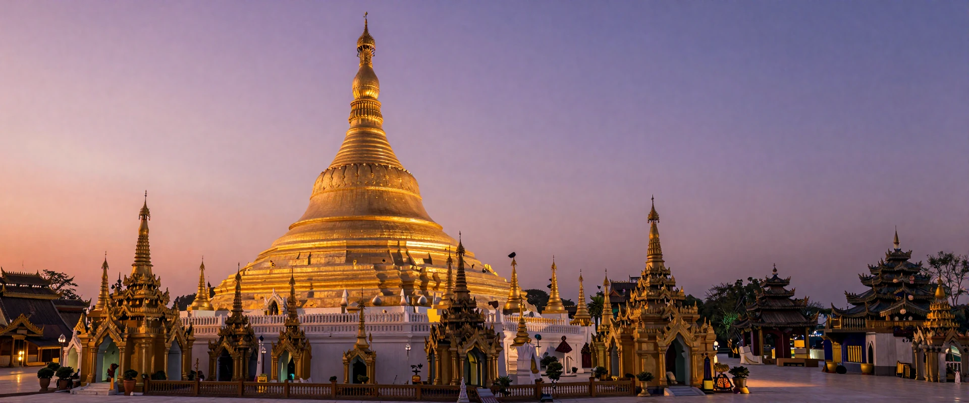 Shwedagon Pagoda in Yangon Myanmar glowing golden at sunset with traditional Buddhist architecture and warm evening sky