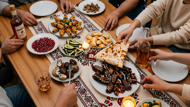 Traditional Armenian feast table with dolma lavash khorovats and Ararat cognac in warm candlelight family gathering setting
