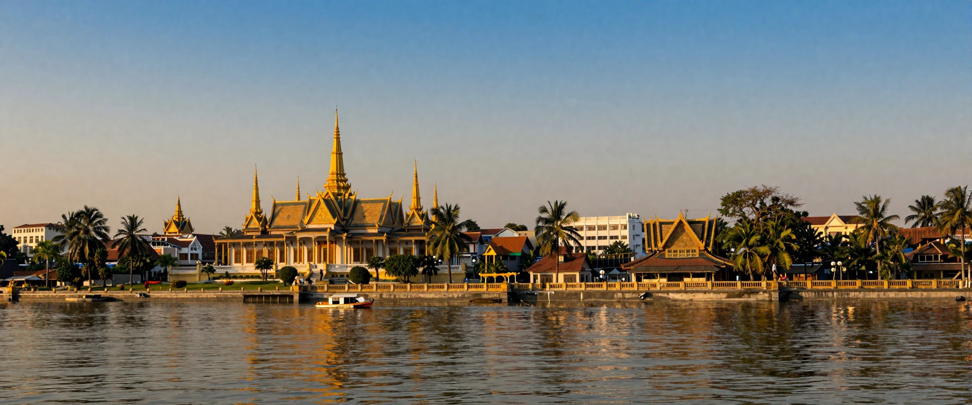 Phnom Penh Royal Palace golden spires along the Tonle Sap riverside at sunset showcasing Cambodian architecture and culture